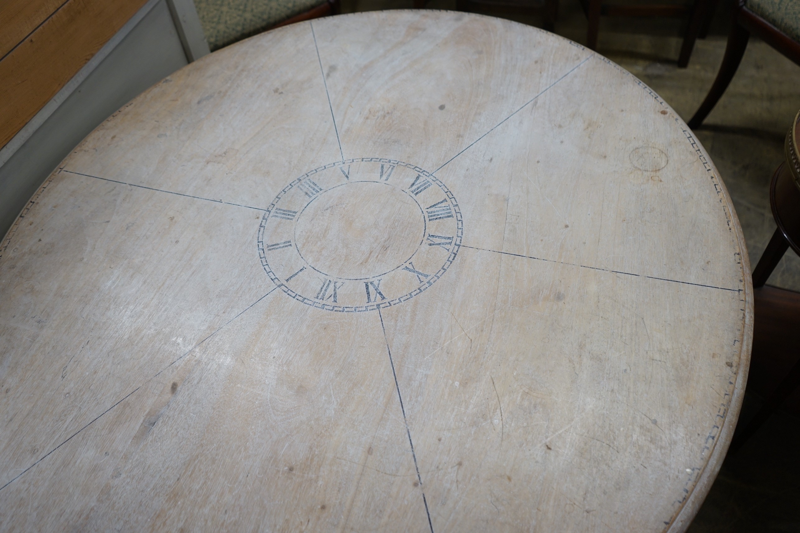 A Victorian style circular painted pine circular dining table on painted cast metal base, diameter 125cm, height 73cm